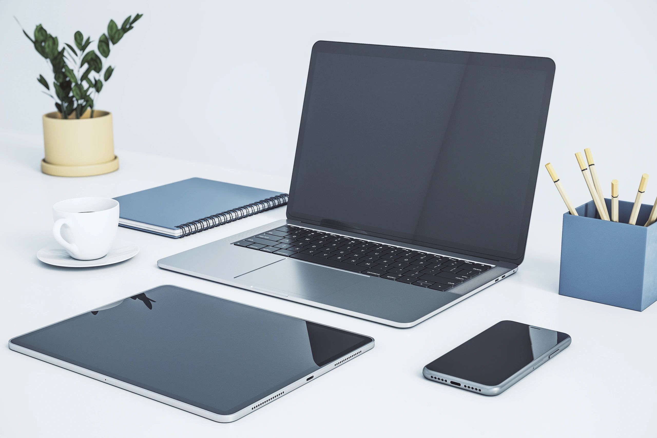 Modern workspace with laptop, tablet, and smartphone